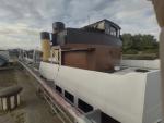 Queen Mary adjacent to Glasgow Science Centre.